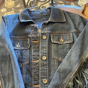 Hand crafted denim jacket with leather fringe.